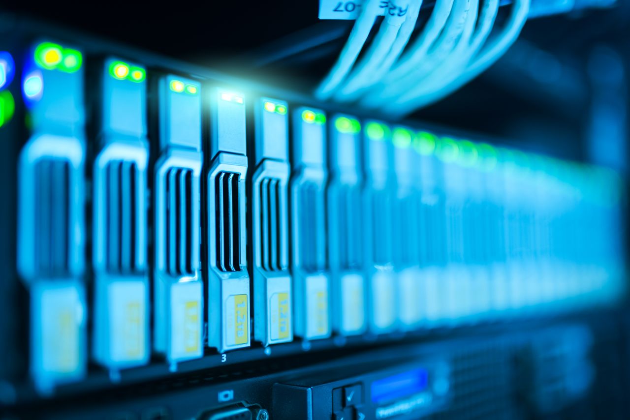 gallery-1 Detailed image of a server rack with glowing lights in a modern data center.