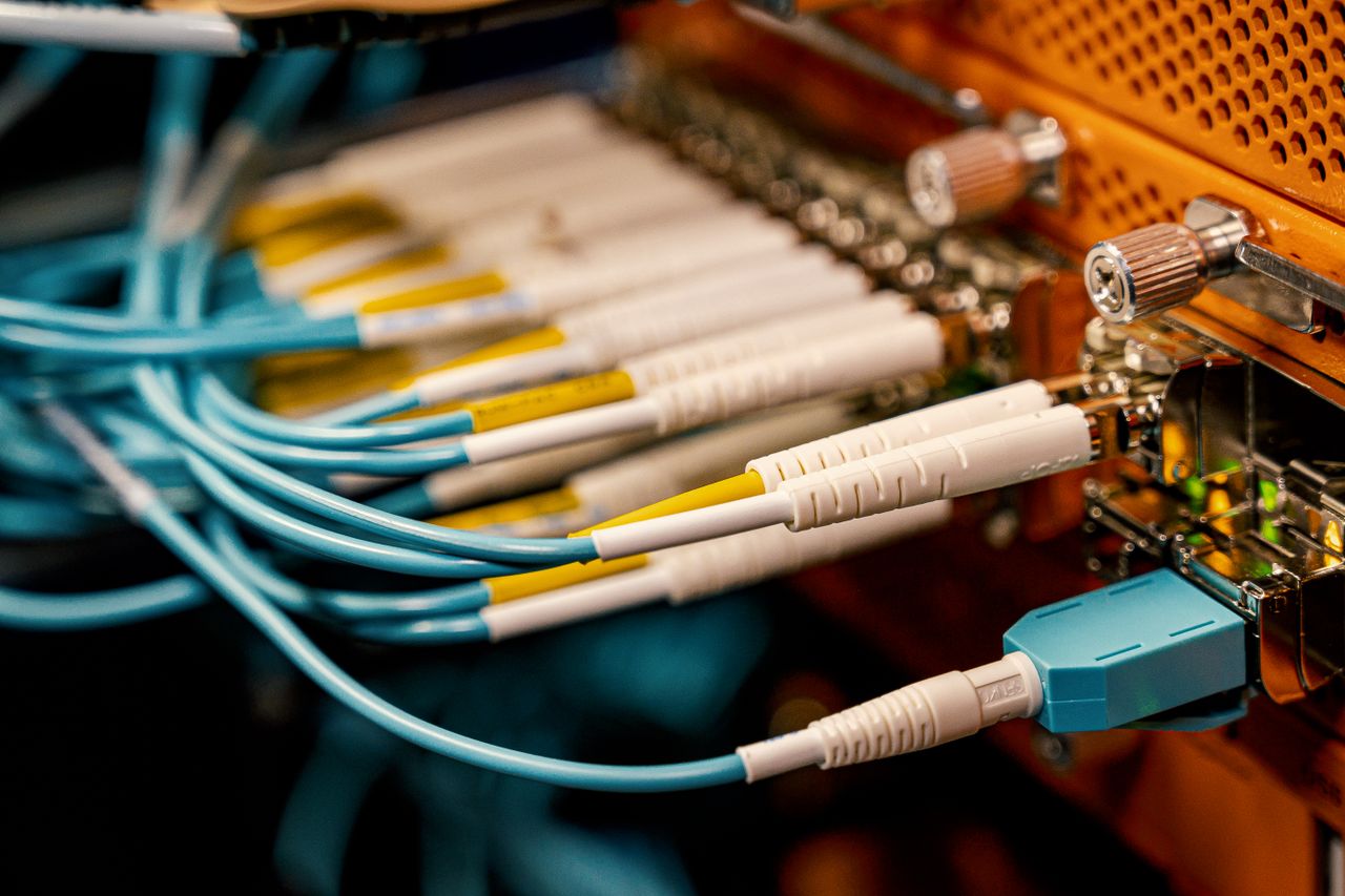 services-01 From above of optical switch equipment with many similar connectors with rubber cables and metal parts